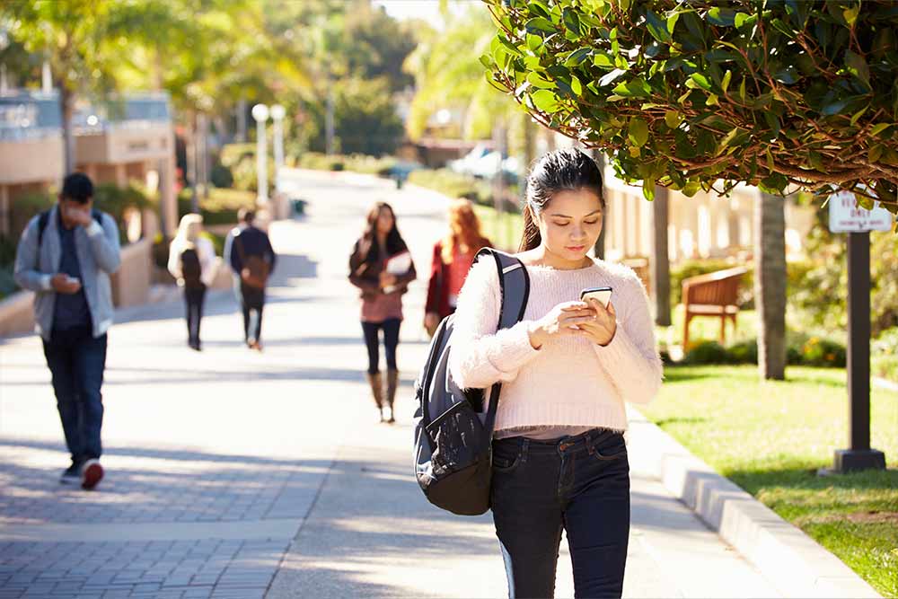 college student on her phone in campus