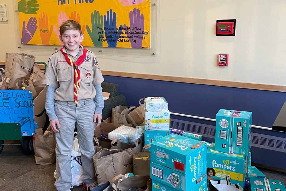 boy scout volunteering with essential needs drive