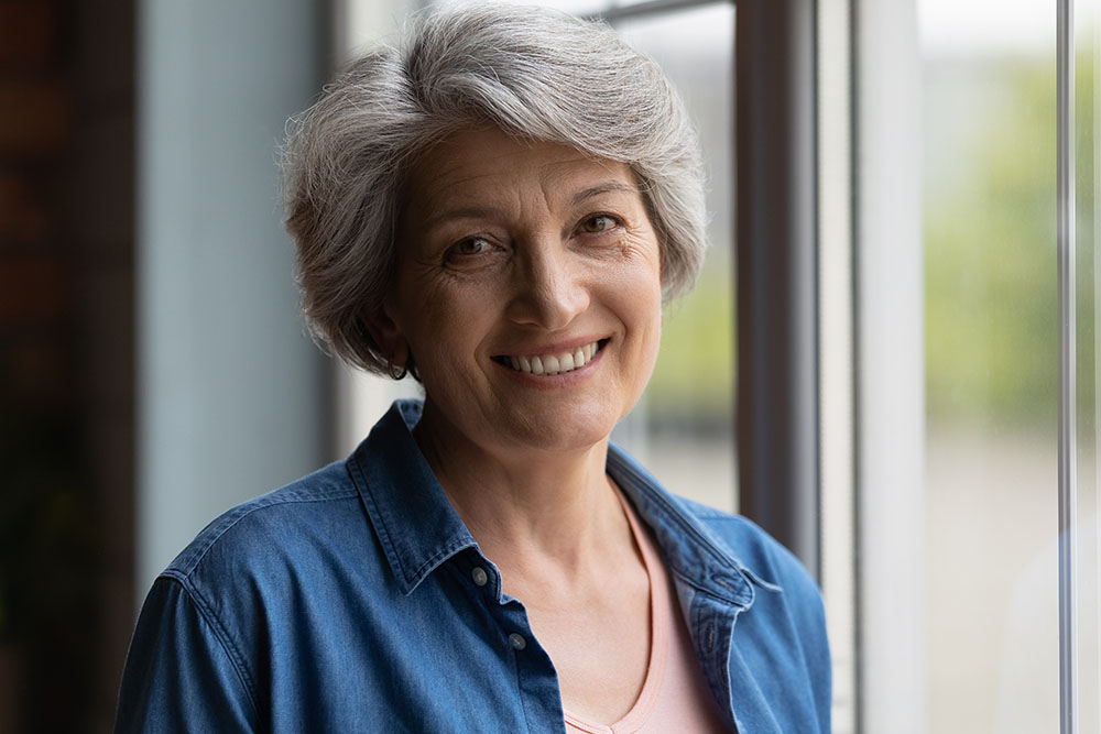 grandmother smiling by window