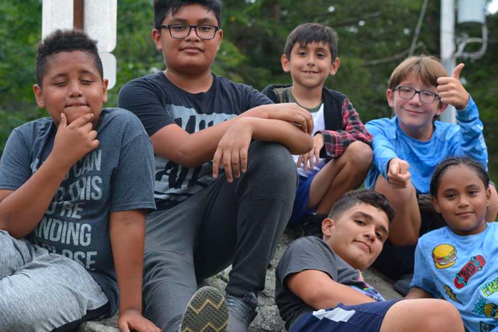 camp hope kids smiling and giving thumbs up to the camera